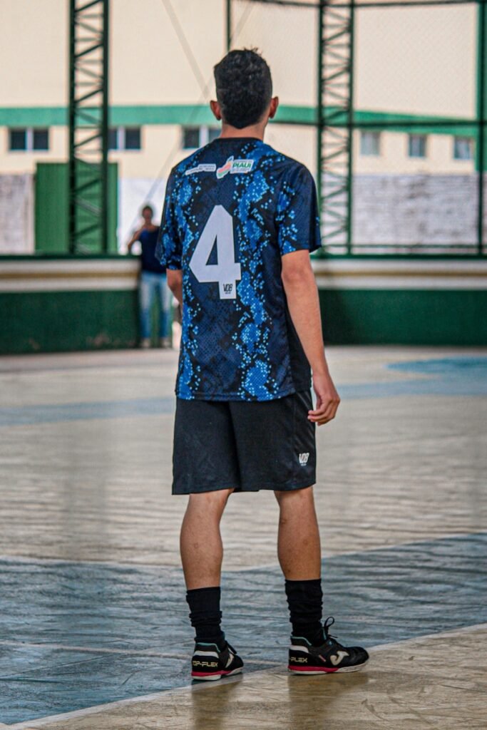 A man standing on a basketball court holding a basketball