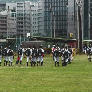 people in black and white uniform on green grass field during daytime